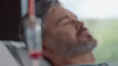 Close Up Shot of Blood Transfusion on Background Man Lying in Modern Clinic Donation Blood Medicine