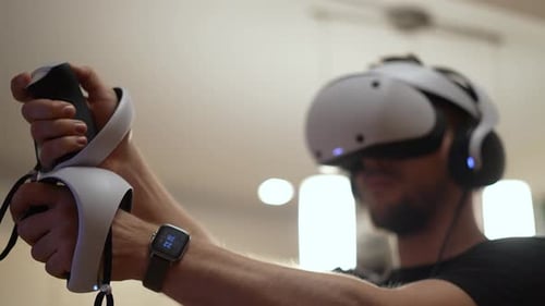 Man Plays Virtual Reality Game with VR Headset