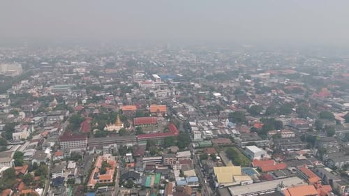 Aerial drone view of Chiang Mai covered in smog during burning season, highlighting severe air