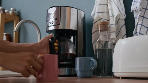 Coffee brewing in kitchen with modern machine