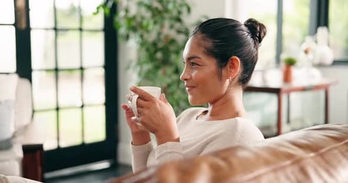 Woman Relaxing at Home Sipping Hot Drink