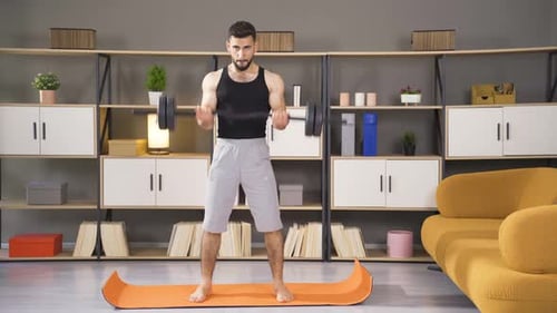 Man Doing Biceps Curls with Barbell at Home