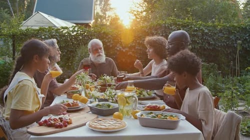 Family Meal in Golden Light in Lush Garden