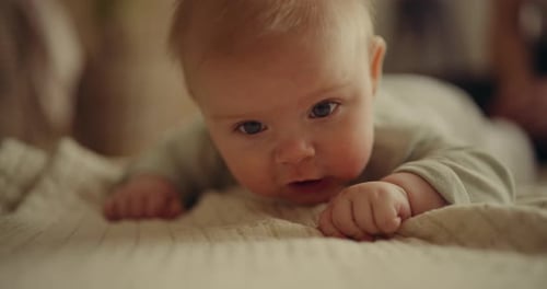 Adorable Infant Lying on Stomach, Looking Around