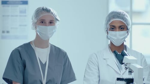 Medical Professionals in Lab with Masks and Microscope