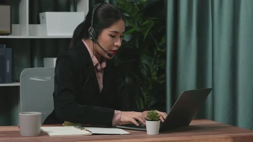 Young Adult Working from Home Office Using Laptop