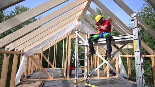Wooden Skeleton Frame Building Performed by Caucasian Construction Worker
