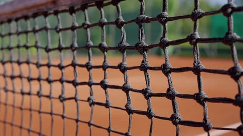 A Detailed Shot of a Tennis Courts Net Showing Its Intricate Pattern and Design