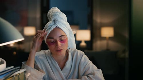 Woman with Towel and Eye Patches on Video Call