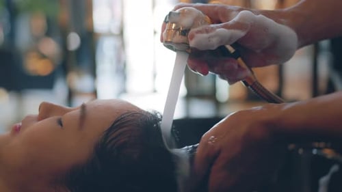 Young Woman Getting Hair Washed at Salon