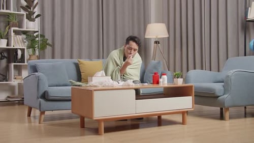 Man with Cold Taking Temperature at Home