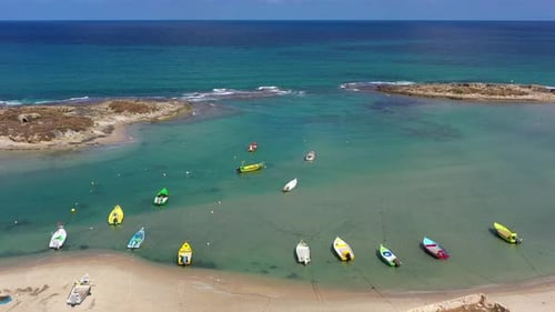 Small Fishing Boats anchored in a shallow lagoon, with packed Fish net onboard, Aerial view