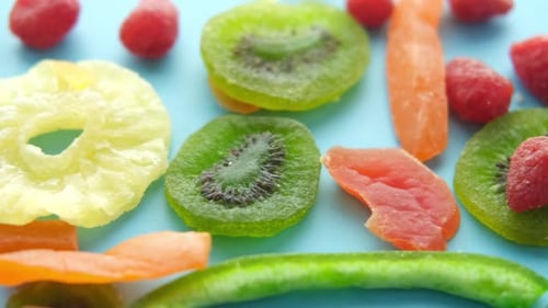 Dried Tropical Fruits Close Up on Blue Surface
