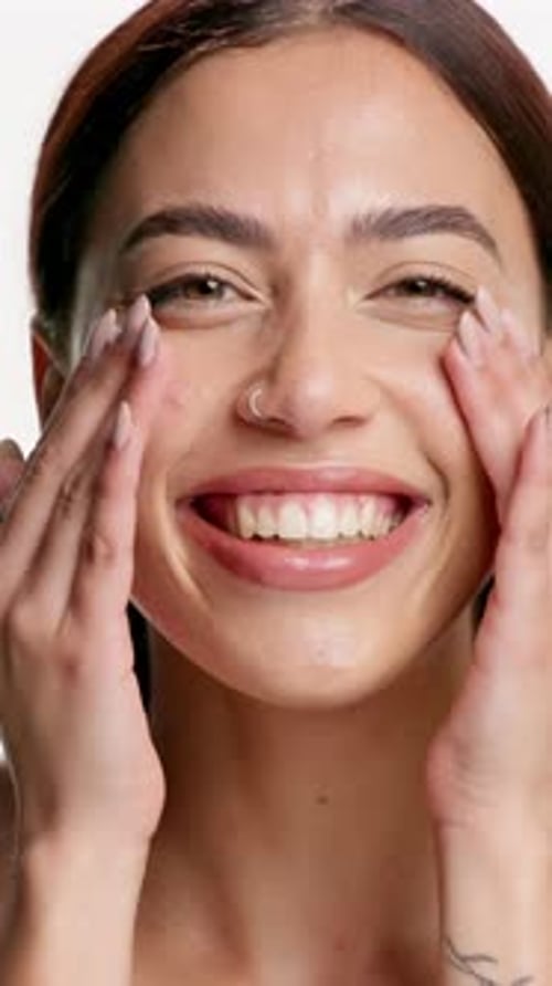 Beauty, woman and happy with face cream in studio for skincare routine, acne treatment or wellness