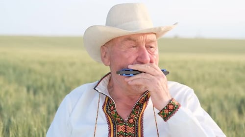 An Old Ukrainian Grandfather Plays the Harmonica He is Dressed in an Embroidered Jacket