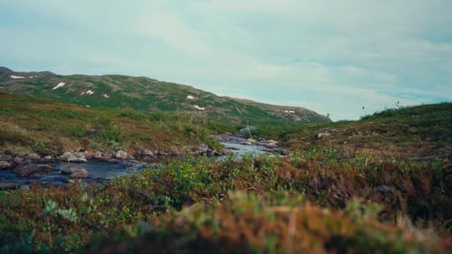 River Flowing Through The Mountains In Indre Fosen, Norway - Wide Shot