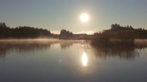 Calm misty morning in a beautiful lake area. Sliding shot from right to left.