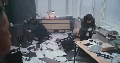 Detectives Investigating Crime Scene in Ransacked Office