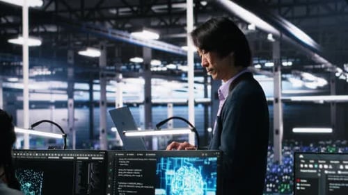 Man and Woman Coding in Modern Tech Office