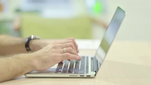 Close up of Man Typing on Laptop