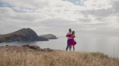 Romantic Couple Embracing on a Cliff Overlooking the Ocean
