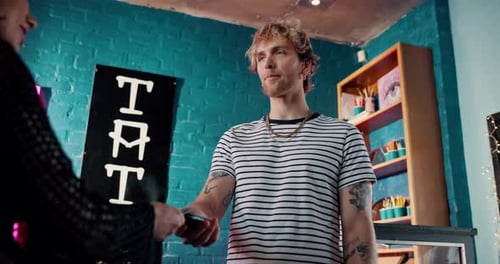 Credit card, pos machine and payment with people in tattoo parlor or store for online banking