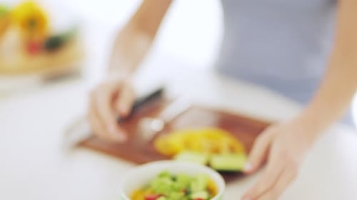 Woman Holds Bowl of Salad in Kitchen