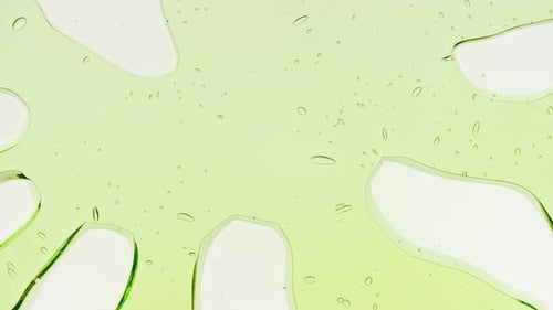 Transparent Green Cosmetic Gel Fluid With Molecule Bubbles and Oil on White Background