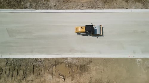 Construction Truck Tipping Dumping Gravel on Road Construction Site Drone Above View Footage