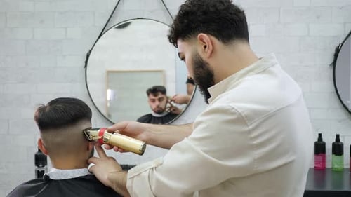 Barber Giving Haircut with Trimmer in Barbershop