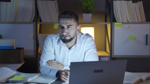 Depressed man works at night.