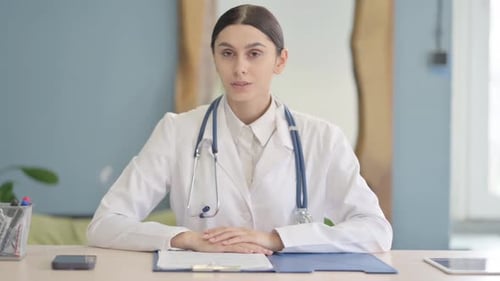 Video Chat by Young Female Doctor in Clinic, Online Consulting