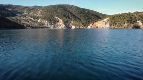 Low altitude drone flight over Mountain lake sunny summer day Peaks distance