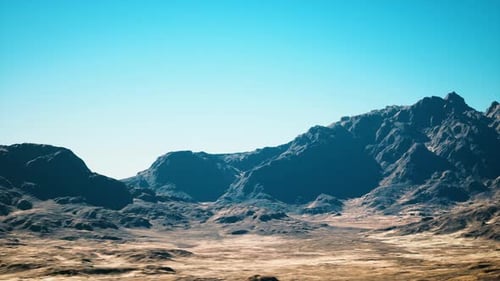 Expansive Sunlit Desert with Rocky Ridges and Sparse Vegetation