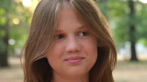 Close Up Headshot Portrait of Smiling Kid Girl in City Park Summer Day Face of Cute Child
