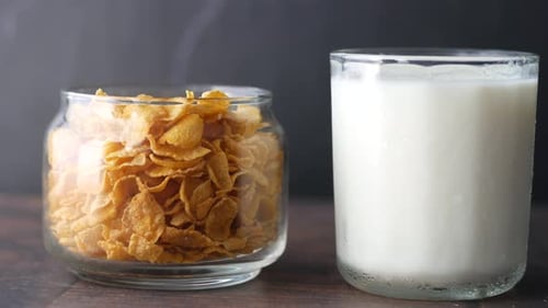 Cornflakes Cereal and Refreshing Milk in Glass