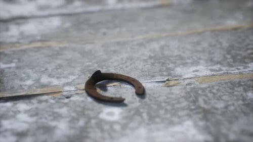 Rustic Rusty Horseshoe Rotating on Weathered Wood Surface