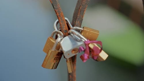 Close-Up Of Love Padlocks On A Rusty Bridge Railing