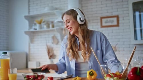 Woman Dancing and Singing While Cooking