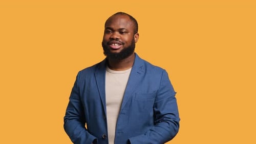 Smiling Man in Blue Blazer on Gold Background
