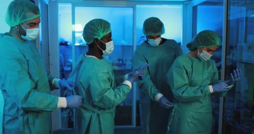 Doctors And Nurse Preparing To Work In Hospital During Coronavirus Pandemic Outbreak - Multiracia...