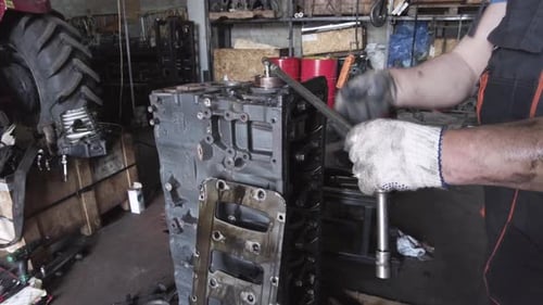 Mechanic Repairing Engine Block in Auto Repair Shop