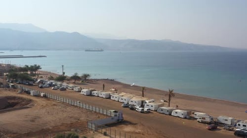 HaDatiyim beach camping site with many caravan cars parked at the coastline on a sunny day, Eilat C