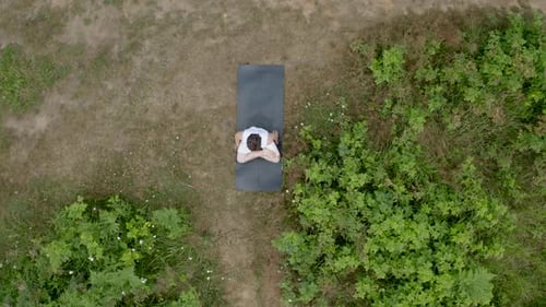 Young Adult Doing Yoga in Nature