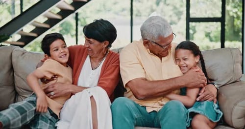 Grandparents Embrace Grandchildren on Couch