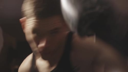 Boxer Practicing Punches in Boxing Gloves