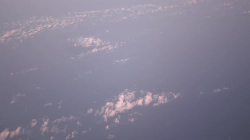 view of sky while flying over fluffy cloud sky scape in daytime ,Aerial view above the clouds and sk