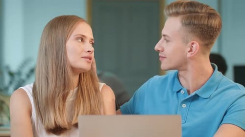 Young Man Flirting with Girl at Office. Happy Colleagues Smiling to Each