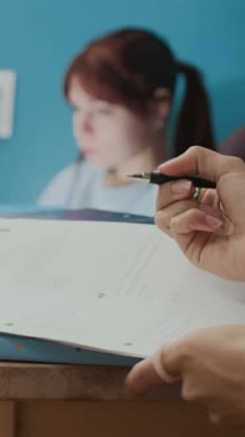 Close-up of Unrecognisable College Girl Doing Math Homework near Textbooks