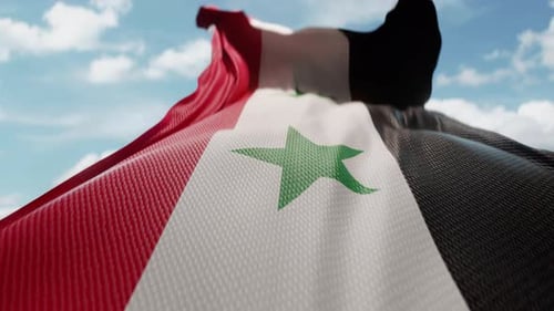 Realistic Syrian Flag Waving Against Blue Sky and Clouds